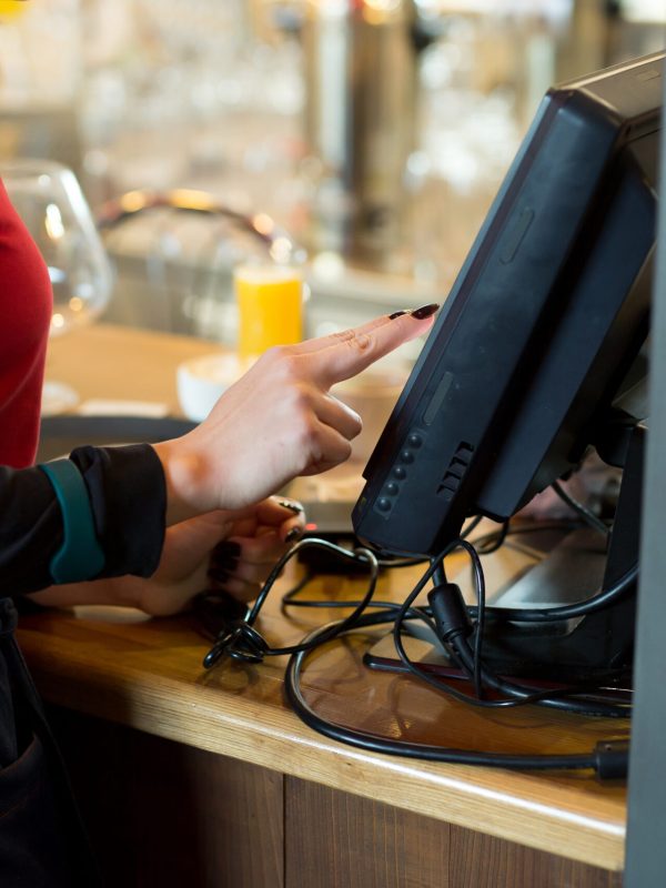 A waiter of a modern cafe or bar enters an order or payment via a tablet or a seekipper.